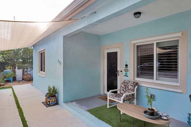 view of exterior entry featuring stucco siding