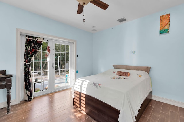 bedroom featuring visible vents, baseboards, ceiling fan, wood tiled floor, and access to outside