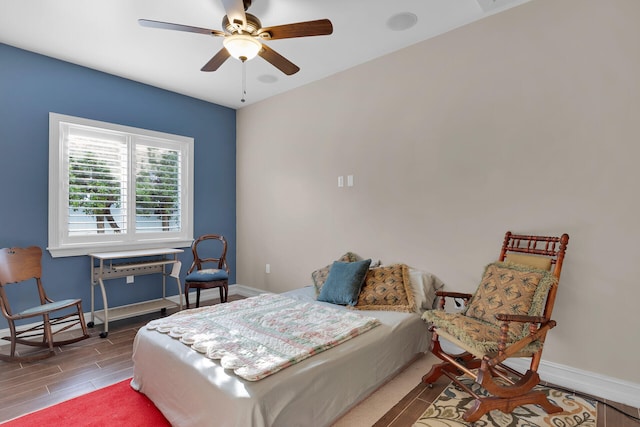 bedroom with ceiling fan, baseboards, and wood finished floors