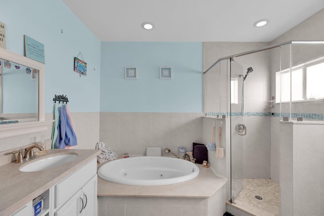 bathroom featuring recessed lighting, vanity, a stall shower, and a whirlpool tub