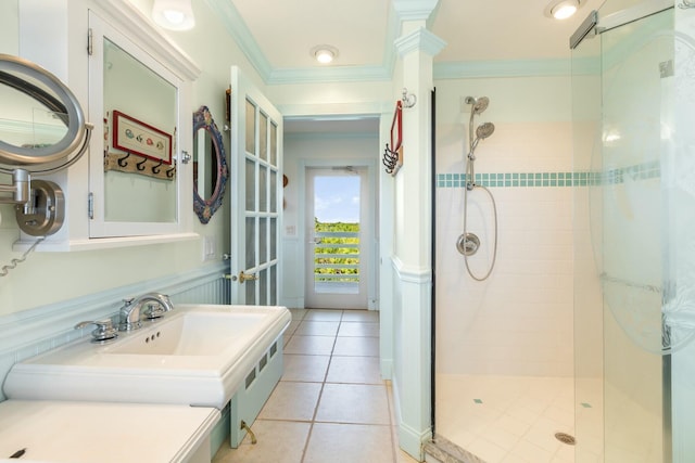 bathroom featuring a shower with door, ornamental molding, tile patterned flooring, and ornate columns