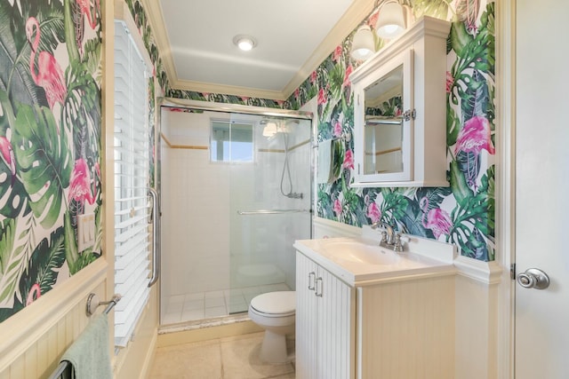 bathroom with toilet, ornamental molding, vanity, and walk in shower