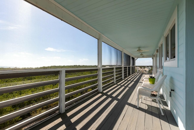 wooden deck featuring ceiling fan