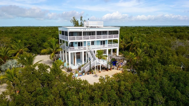 rear view of property featuring a carport and a sunroom