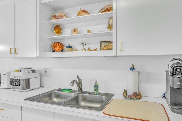 12690 Overseas Hwy Unit 52, Marathon, FL 33050 - kitchen featuring white cabinetry, light countertops, a sink, and open shelves