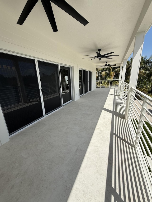 view of patio with a balcony and a ceiling fan