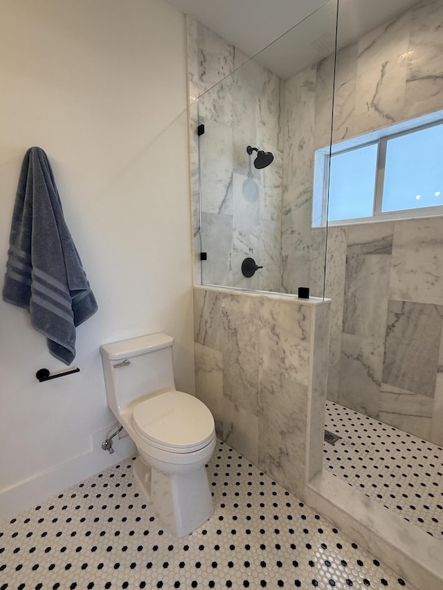 full bathroom featuring baseboards, toilet, and walk in shower