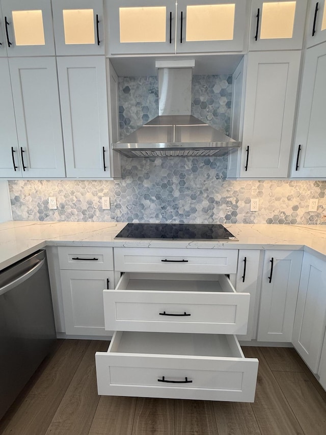 kitchen with dark wood-type flooring, dishwasher, wall chimney range hood, black electric cooktop, and tasteful backsplash