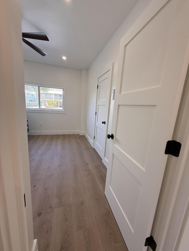 corridor with recessed lighting, baseboards, and dark wood-style floors