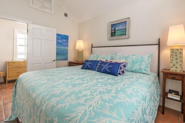 tiled bedroom featuring high vaulted ceiling