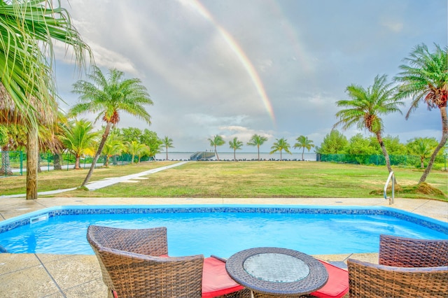 view of pool featuring a yard