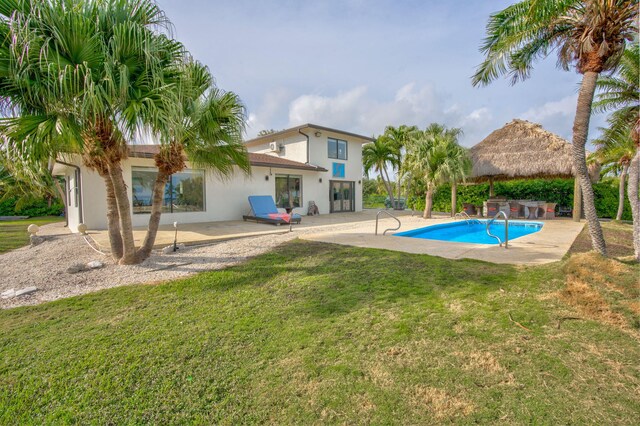 view of pool featuring a gazebo, a lawn, a patio, and exterior bar