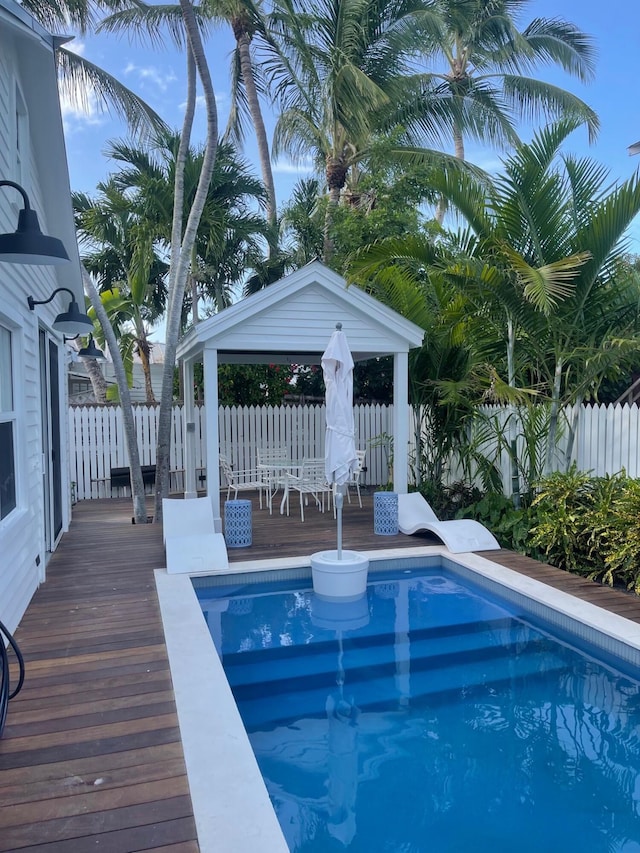 view of swimming pool featuring a wooden deck and a gazebo