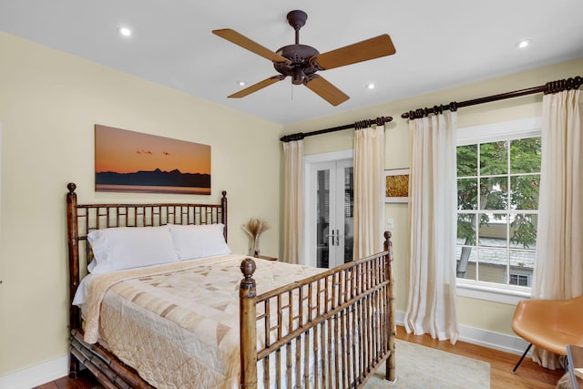 bedroom with light hardwood / wood-style floors, french doors, and ceiling fan