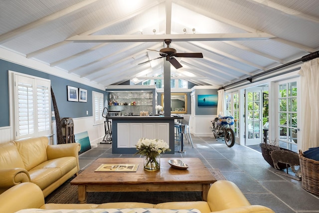 living room with ceiling fan, bar, and lofted ceiling with beams