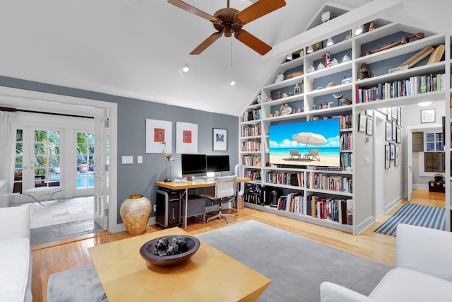 living room with french doors, lofted ceiling, and hardwood / wood-style floors