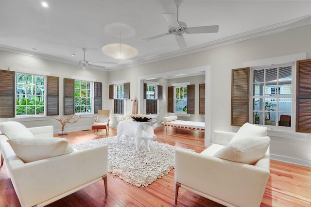 living room featuring ceiling fan, ornamental molding, and hardwood / wood-style floors