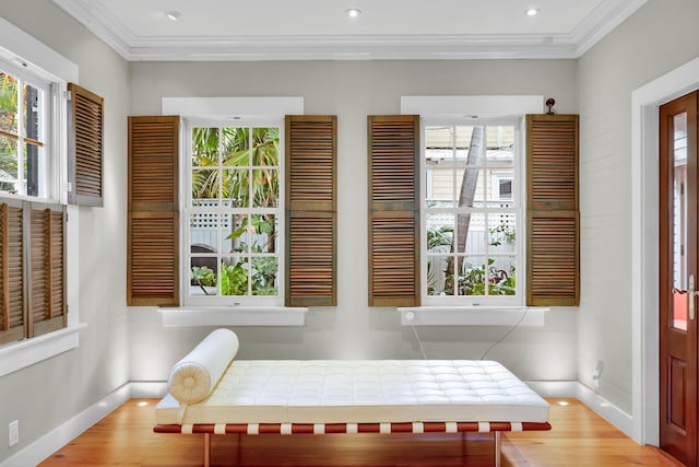 dining area featuring plenty of natural light, ornamental molding, and wood-type flooring