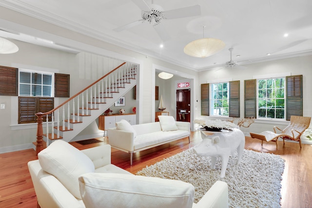 living room featuring crown molding, ceiling fan, and wood-type flooring