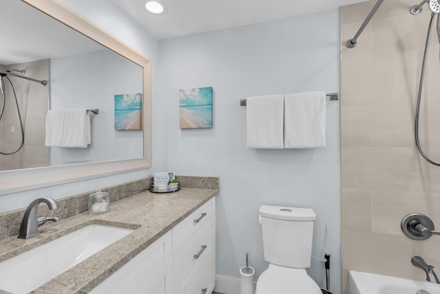 full bathroom featuring tiled shower / bath, vanity, and toilet