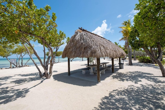 view of property's community featuring a beach view and a water view