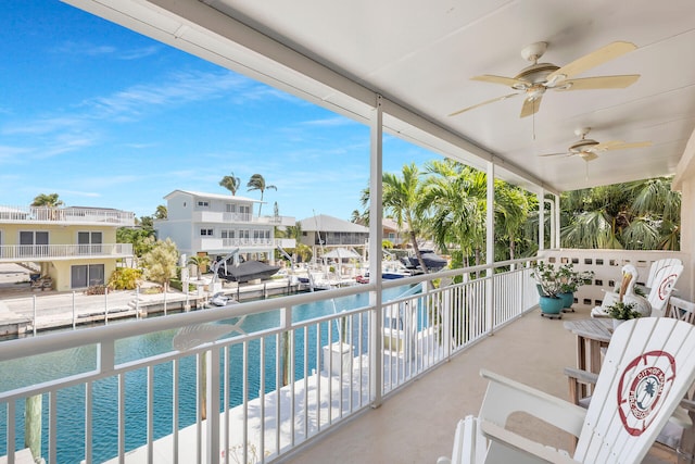 balcony with a water view and ceiling fan