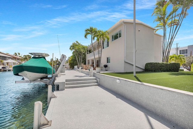 exterior space featuring a water view and a yard