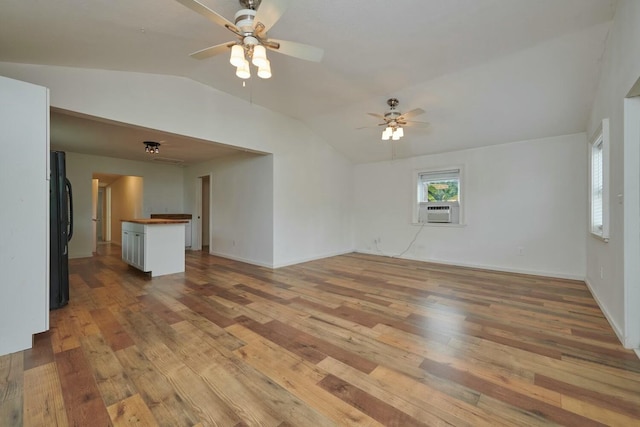 unfurnished living room featuring vaulted ceiling, cooling unit, ceiling fan, and light wood-type flooring