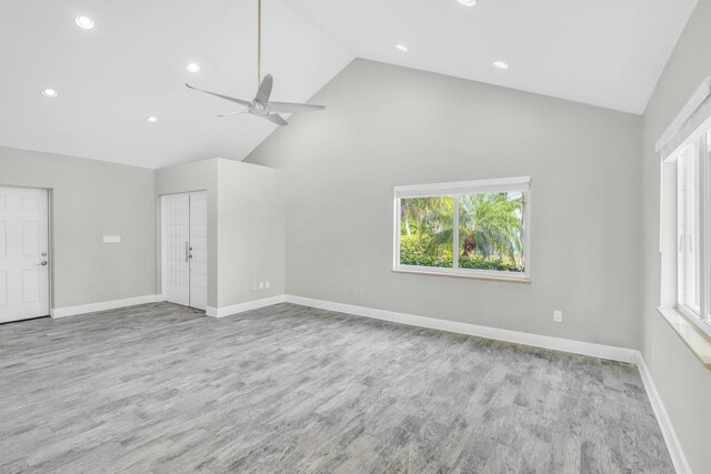 interior space featuring light wood-style floors, plenty of natural light, and baseboards