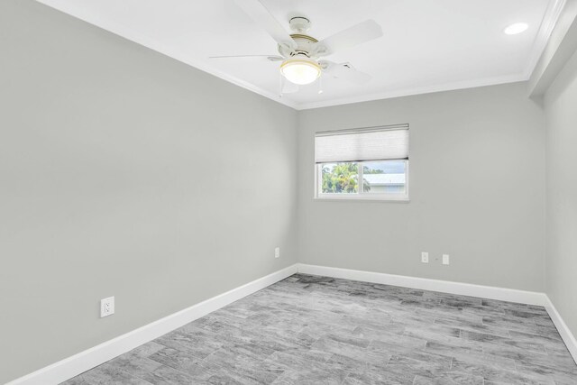 spare room with light wood-type flooring, crown molding, baseboards, and ceiling fan