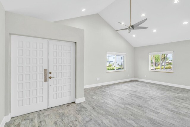 unfurnished bedroom with baseboards, high vaulted ceiling, recessed lighting, and light wood-style floors