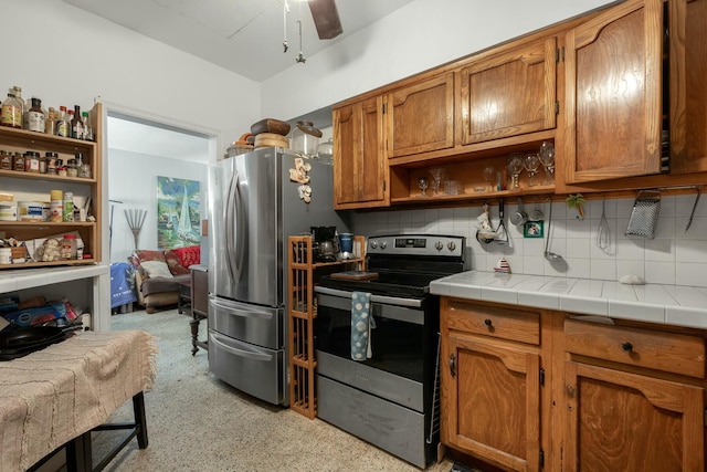 1302 11th St, Key West, FL 33040 - kitchen with stainless steel appliances, open shelves, backsplash, and brown cabinets