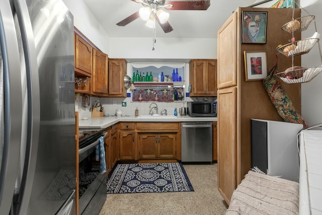 1302 11th St, Key West, FL 33040 - kitchen featuring stainless steel appliances, a sink, a ceiling fan, light countertops, and decorative backsplash