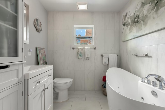 1302 11th St, Key West, FL 33040 - bathroom with tile walls, a freestanding tub, marble look tiles, vanity, and toilet