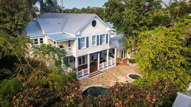 back of property featuring a patio and a balcony