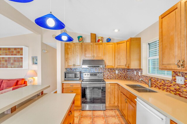 kitchen with appliances with stainless steel finishes, pendant lighting, lofted ceiling, sink, and decorative backsplash