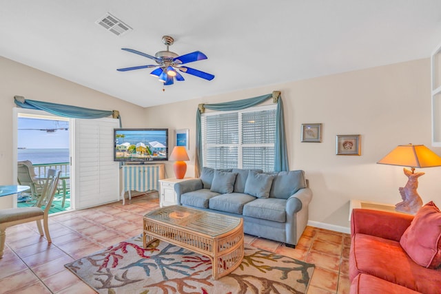 living room with light tile patterned floors, vaulted ceiling, and ceiling fan