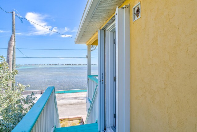 balcony featuring a water view