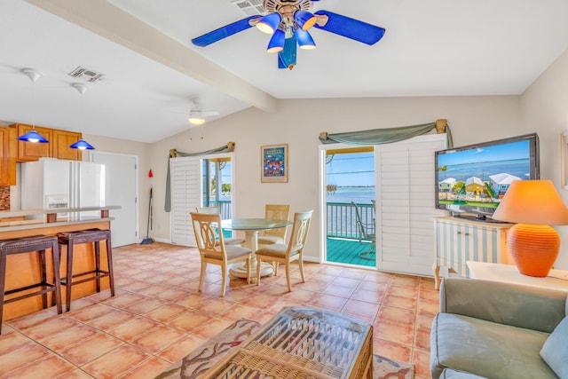 tiled dining room featuring lofted ceiling with beams and ceiling fan