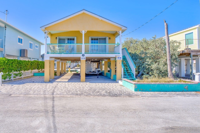 raised beach house with a carport and covered porch