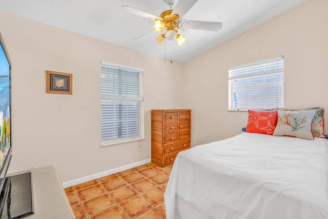 tiled bedroom featuring ceiling fan