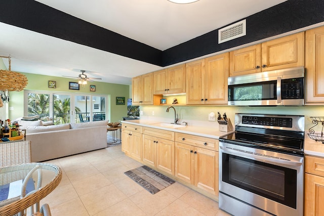 136 Aregood Ln Unit 2A, Islamorada, FL 33036 - kitchen with visible vents, light brown cabinets, light countertops, a sink, and appliances with stainless steel finishes