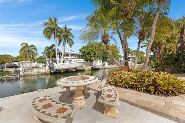 view of patio / terrace featuring a dock and a water view