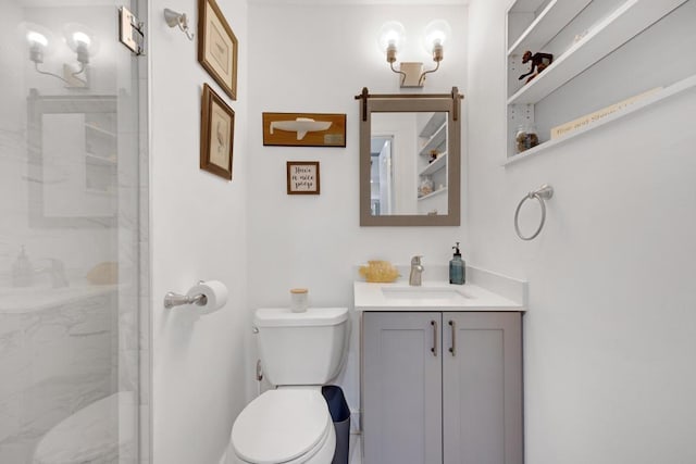 bathroom with a shower with door, vanity, and toilet