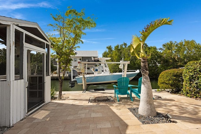 view of patio with a dock and a water view