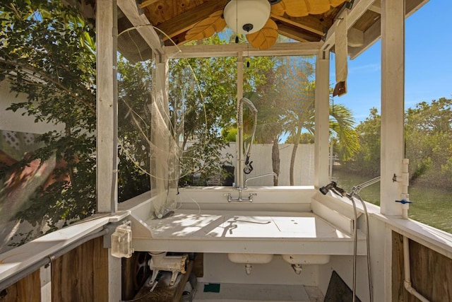 unfurnished sunroom featuring a water view