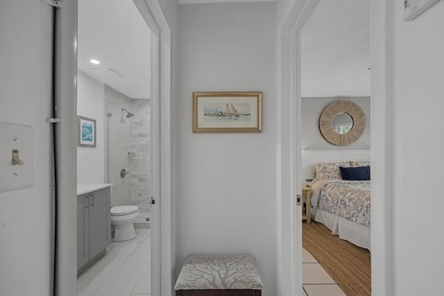 bathroom featuring tile patterned floors, toilet, a shower with shower door, and vanity