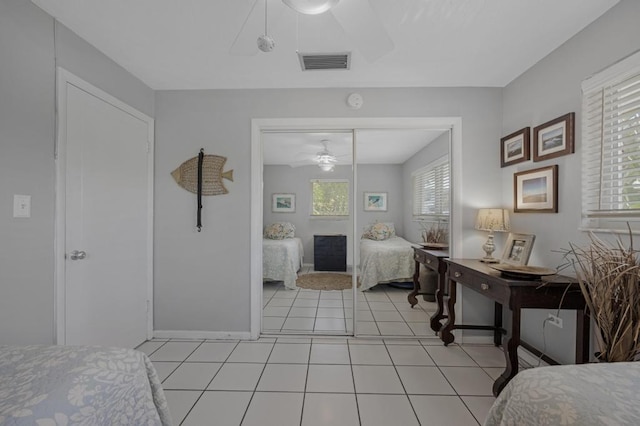 bedroom with light tile patterned flooring and a closet