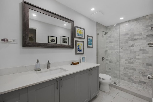 bathroom with vanity, tile patterned floors, a shower with door, and toilet