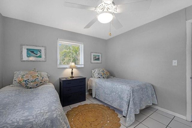 tiled bedroom featuring ceiling fan